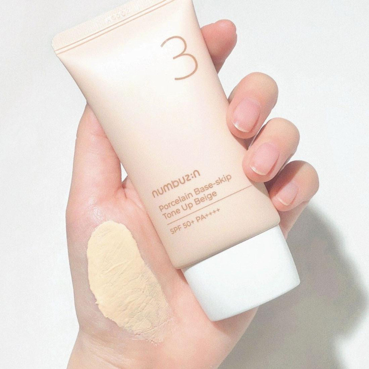 NUMBUZIN 3 Porcelain Base Skip Tone Up Beige SPF 50+ PA++++ كريم واقي الشمس مع تون اب للتفتيح الفوري من نمبوزين